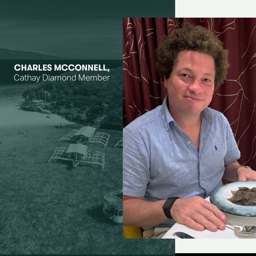 Charles McConnell smiling over a plate of food in a restaurant.